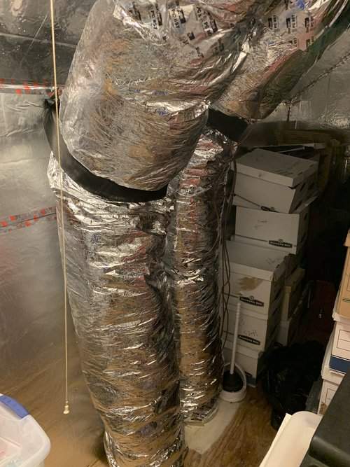 Insulated flex ducts running up through a storage closet