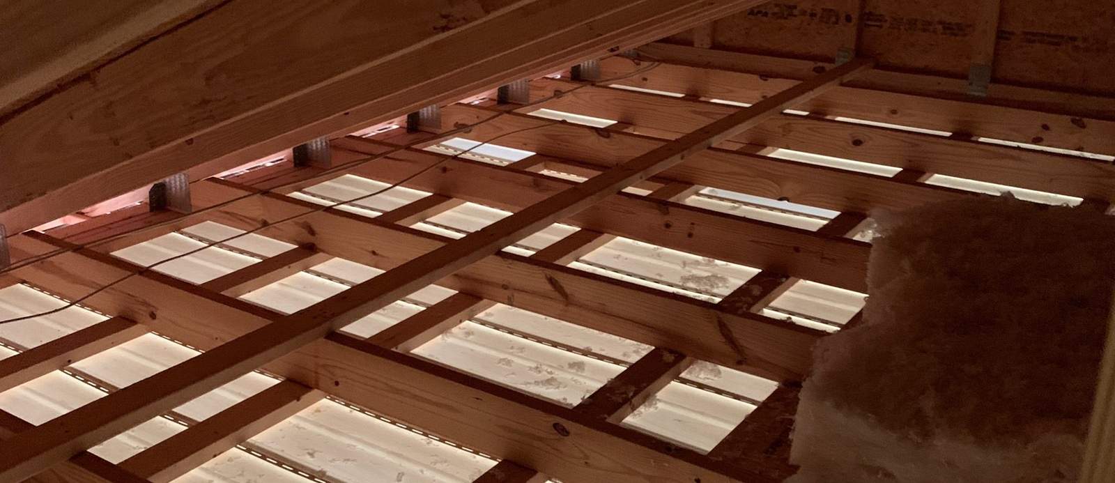 Attic floor joists with little insulation between them