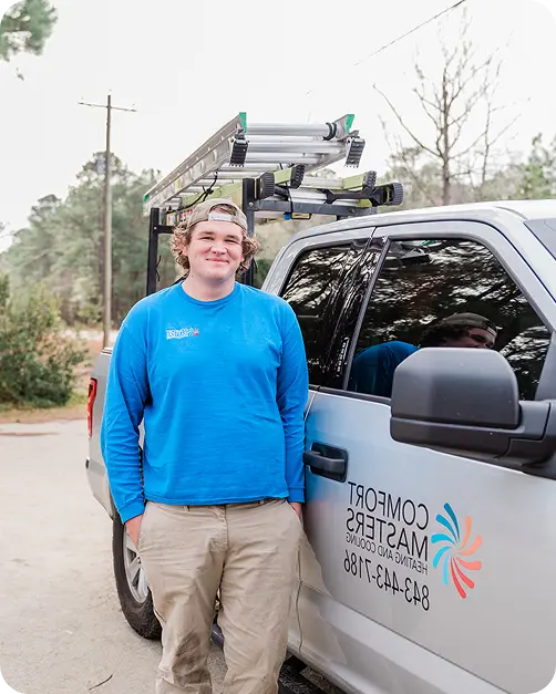 cody the lead technician stands by a comfort masters truck