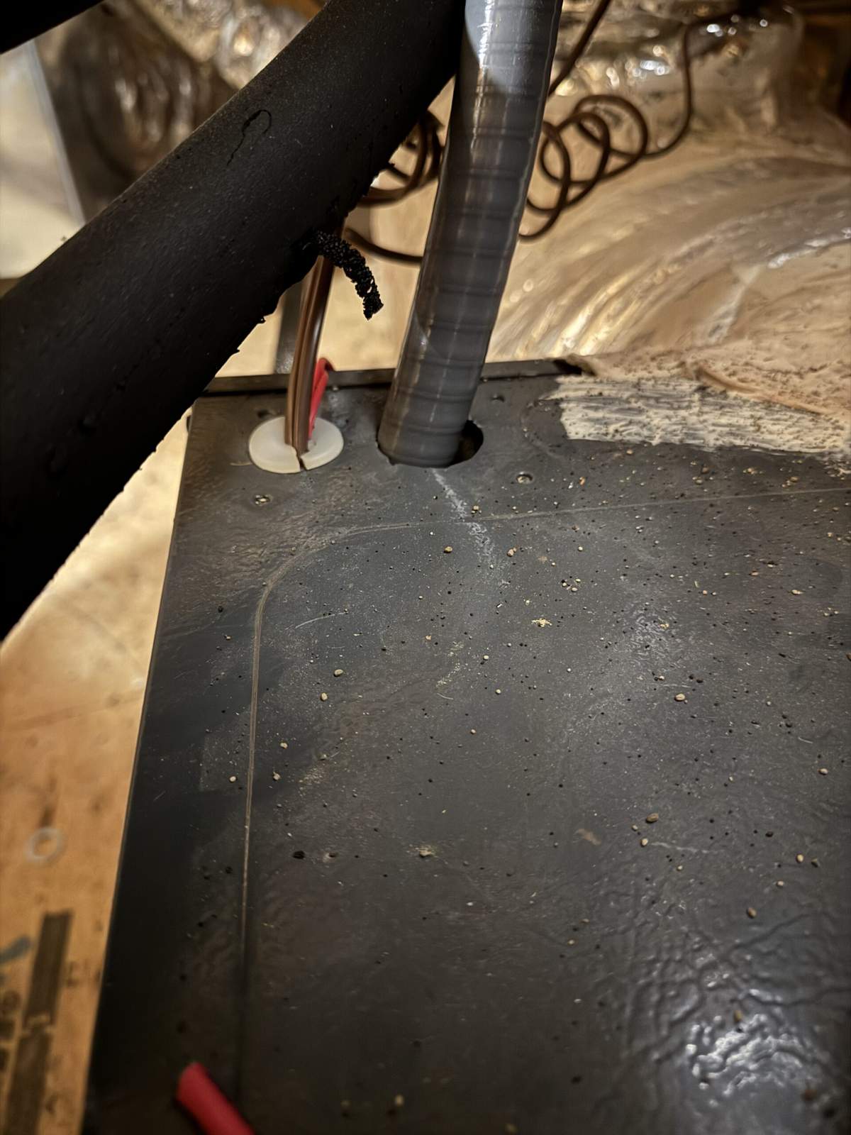 Improper electrical connection at an HVAC unit that passed inspection but should have a Romex connector