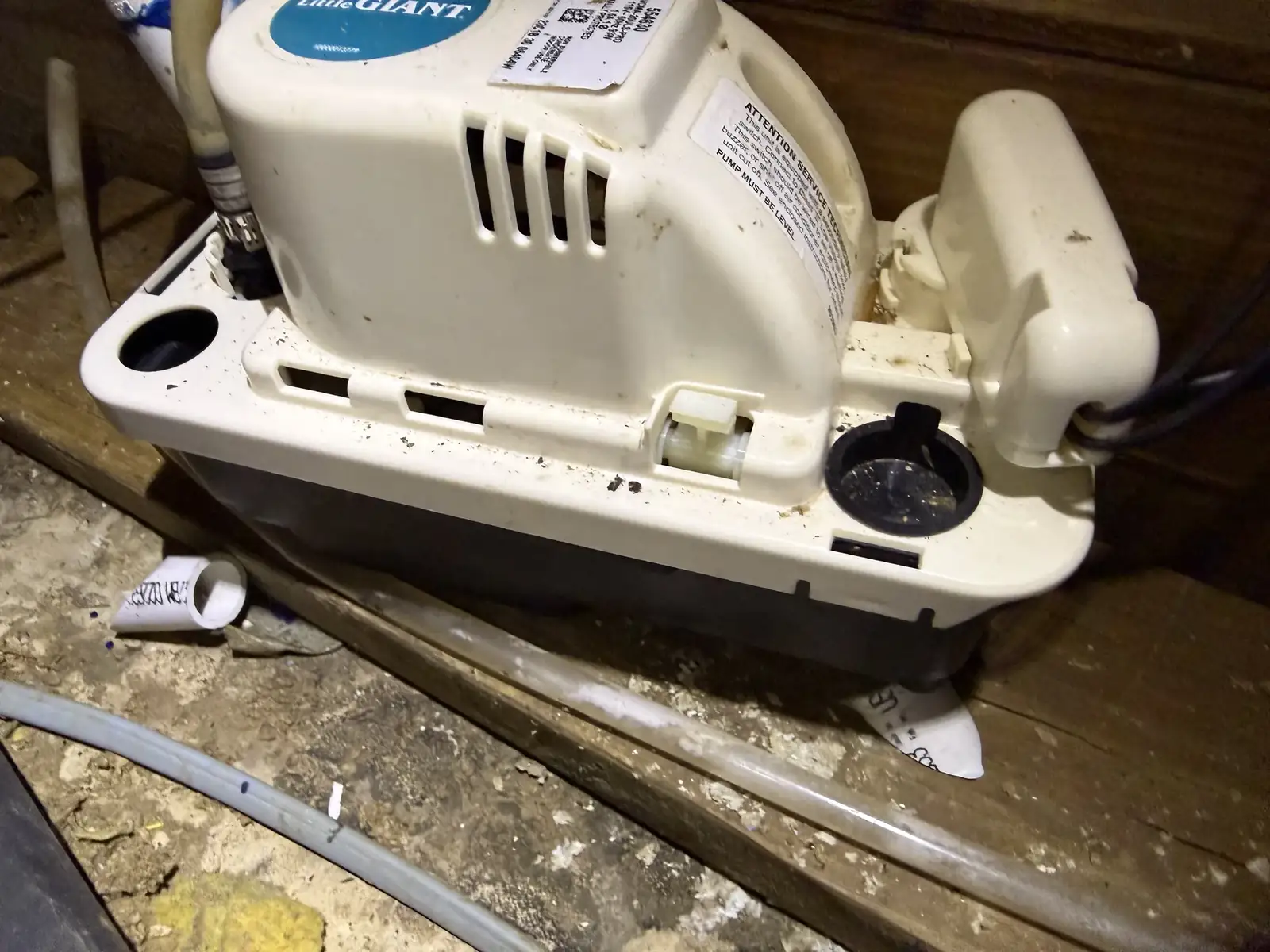 Uninsulated attic condensate lines sweating onto framing in a coastal home