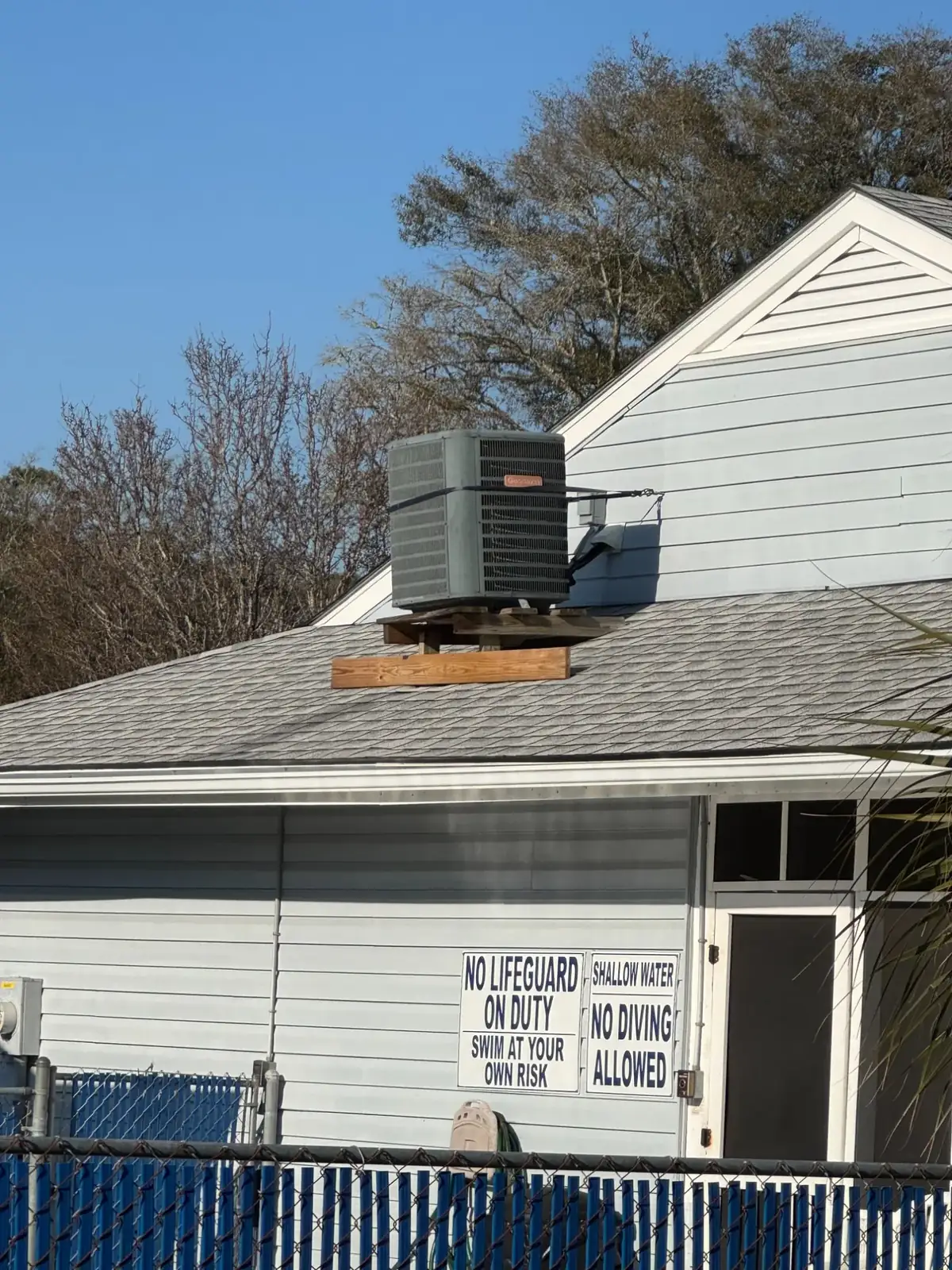 Goodman condenser on a makeshift wood platform (North Myrtle Beach, SC)
